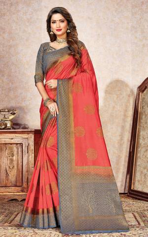 Shine Bright Wearing This Designer Silk Based Saree In Dark Peach Color Paired With Contrasting Grey Colored Blouse. This Saree And Blouse Are Fabricated On Nylon Silk Beautified With Weave. 