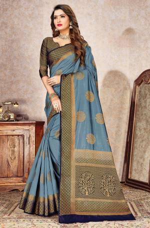Celebrate This Festive Season In A Proper Traditional Look Wearing This Designer Weaved Saree In Steel Blue Color Paired With Contrasting Navy Blue Colored Blouse. This Saree And Blouse Are Fabricated On Rich Nylon Silk. 