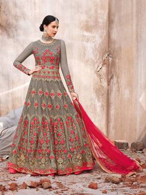 Flaunt Your Rich And Elegant Taste Wearing This Heavy Designer Floor length Suit In Grey And Dark Pink Color. Its Top And dupatta Are Net Based Beautified With Heavy Embroidery Paired With Santoon Fabricated Bottom. 