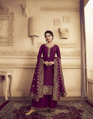 You Will Definitely Earn Lots Of Compliments Wearing This Designer Straight Suit With Heavy Dupatta Concept. This Lovely Wine Colored Suit Is Silk Based Beautified with Weaving And Hand Work. Its Rich Color And Fabric Gives An Attractive Look To Your Personality. 