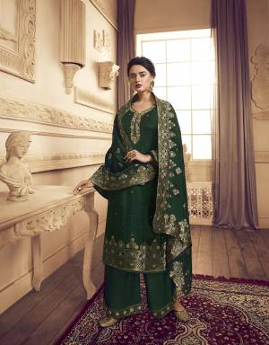 You Will Definitely Earn Lots Of Compliments Wearing This Designer Straight Suit With Heavy Dupatta Concept. This Lovely Dark Green Colored Suit Is Silk Based Beautified with Weaving And Hand Work. Its Rich Color And Fabric Gives An Attractive Look To Your Pers