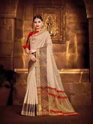 Flaunt Your Rich And Elegant Taste Wearing This Rich Fabricated Silk Based saree In Cream Color Paired With Red Colored Blouse. It Is Beautified With Weave Which Also A Proper Traditional Touch To Your Look. 
