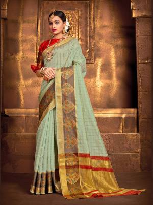 Flaunt Your Rich And Elegant Taste Wearing This Rich Fabricated Silk Based saree In Pastel Green Color Paired With Red Colored Blouse. It Is Beautified With Weave Which Also A Proper Traditional Touch To Your Look. 