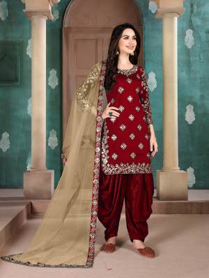 Here Is An Attractive Looking Mirror Embroidered Heavy Designer Suit In Maroon Color Paired With Beige colored Dupatta. Its Top Is Fabricated On Art Silk Paired With Santoon Bottom And Net Fabricated Dupatta. Also, Its Dupatta Is Beautified With Embroidered Lace Border. 