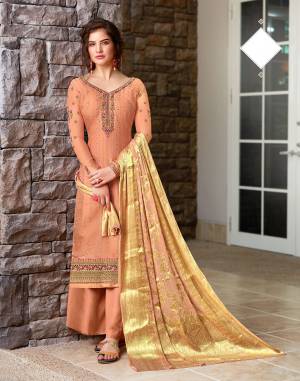 You Will Definitely Earn Lots Of Compliments Wearing This Designer Straight Suit In Dark Peach Color. Its Top Is Tussar Silk Based Beautified With Heavy Embroidery Paired With Santoon Bottom And Jacquard Silk Fabricated Dupatta. 