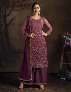 Here Is A Very Pretty Designer Straight Suit In All Over Wine Color. Its Heavy Embroidered Top Is Fabricated On Net Paired With Silk Based Bottom And Chiffon Dupatta. ItsLovely Top With Deatiled Embroidery Will Give An Attractive Look To Your Personality. 