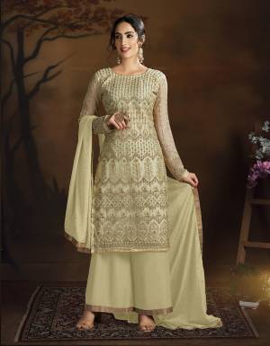 Here Is A Very Pretty Designer Straight Suit In All Over Cream Color. Its Heavy Embroidered Top Is Fabricated On Net Paired With Silk Based Bottom And Chiffon Dupatta. ItsLovely Top With Deatiled Embroidery Will Give An Attractive Look To Your Personality. 