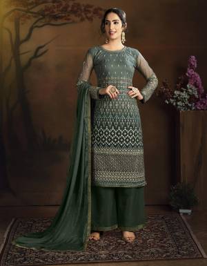Here Is A Very Pretty Designer Straight Suit In All Over Dark Green Color. Its Heavy Embroidered Top Is Fabricated On Net Paired With Silk Based Bottom And Chiffon Dupatta. ItsLovely Top With Deatiled Embroidery Will Give An Attractive Look To Your Personality. 
