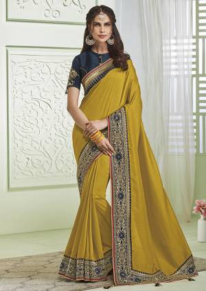 Celebrate This Festive Season With beauty And Comfort Wearing This Designer Saree In Pear Green Color Paired With Contrasting Navy Blue Colored Blouse. This Saree And Blouse Are Silk Based Beautified With Minimal Embroidery. 