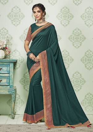 Enhance Your Personality Wearing This Rich Silk Based Designer Saree In Teal Blue color. It Is Beautified With Pretty Embroidery Over The Lace Border. 