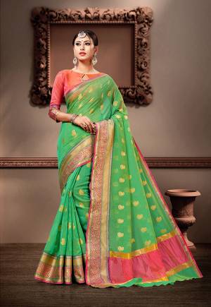 Pretty Simple And Elegant Looking Saree Is Here In Green Color Paired With Pink Colored Blouse. This Saree And Blouse Are Fabricated On Cotton Silk Beautified With Weave. 