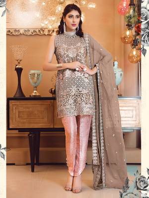 Look Attractive In This Heavy Embroidered Designer Suit In Light Brown Colored Top And Dupatta Paired With Contrasting Pink Colored Bottom. Its Top Is Fabricated On Georgette Paired With Jacquard Silk Bottom And Chiffon Dupatta. 