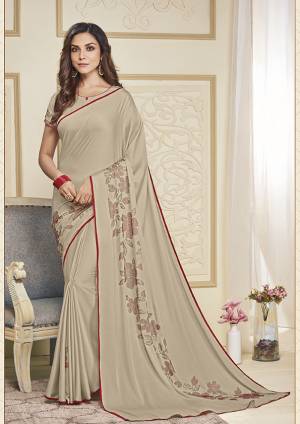 Adorn The Pretty Angelic Look Wearing This Designer Elegant Looking Saree In Cream Color. This Pretty Saree And Blouse Are Fabricated On Soft Satin Beautified With Pretty Stone Work. Its Lovely Color And Stone Work Will Definitely Earn You Lots Of Compliments From Onlookers. 
