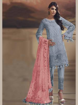Grab This Pretty Straight Suit In Grey Color Paired With Contrasting Pink Dupatta. Its Top Is Fabricated On Tissue Silk Paired With Santoon Bottom And Net Fabricated Dupatta. Buy This Suit Now.