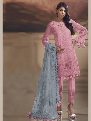 Grab This Pretty Straight Suit In Light Pink Color Paired With Contrasting Grey Dupatta. Its Top Is Fabricated On Tissue Silk Paired With Santoon Bottom And Net Fabricated Dupatta. Buy This Suit Now.