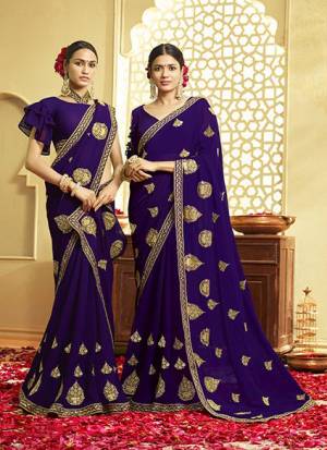Adorn The Pretty Angelic Look Wearing This Designer Saree In Violet Color Paired With Red Colored Blouse. This Saree And Blouse Are Fabricated On Georgette Beautified With Jari Embroidery. Buy Now.