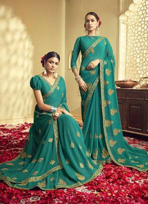 Adorn The Pretty Angelic Look Wearing This Designer Saree In Turquoise Blue Color Paired With Red Colored Blouse. This Saree And Blouse Are Fabricated On Georgette Beautified With Jari Embroidery. Buy Now.