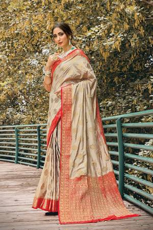 Flaunt Your Rich And Elegant Taste Wearing This Silk Based Saree In Beige Color Paired With Red Colored Blouse, This Pretty Weaved Saree And Blouse Are Fabricated On Nylon Silk Which Gives A Rich Look To Your Personality.