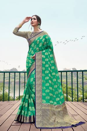 Flaunt Your Rich And Elegant Taste Wearing This Silk Based Saree In Sea Green Color Paired With Royal Blue Colored Blouse, This Pretty Weaved Saree And Blouse Are Fabricated On Nylon Silk Which Gives A Rich Look To Your Personality.
