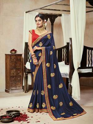 Add This Very Pretty Attractive Looking Designer Saree To Your Wardrobe In Navy Blue Color Paired With Contrasting Red Colored Blouse. This Saree Is Fabricated On Satin Silk Paired With Art Silk Fabricated Blouse. 