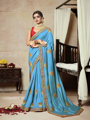 Add This Very Pretty Attractive Looking Designer Saree To Your Wardrobe In Sky Blue Color Paired With Contrasting Red Colored Blouse. This Saree Is Fabricated On Satin Silk Paired With Art Silk Fabricated Blouse. 