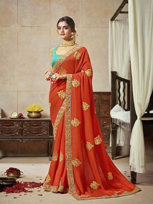 Celebrate This Festive Season With Beauty And Comfort Wearing This Lovely Orange Colored Saree Paired With Sea Green Colored Blouse.  This Saree Is Satin Silk Based Paired With Art Silk Fabricated Blouse. Buy Now.