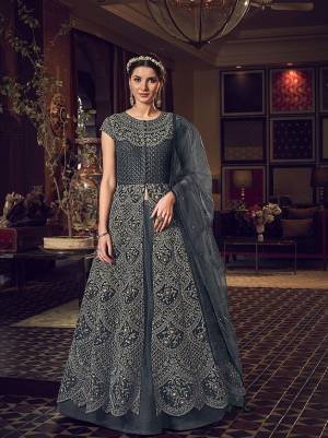 Here Is A Beautiful Grey Colored Two Way Designer Suit With Comes With Two Bottom. Its Top Is Fabricated On Net Beautified With Heavy Embroidery Paired With Net Fabricated Lehenga And Art Silk Fabricated Embroidered Pants. Also It Has Net Fabricated Dupatta. 