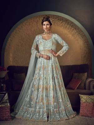 For An Elegant Look, Grab This Heavy Designer Indo-Western Suit In Baby Blue Color. Its Has Beautiful Embroidered Net Based Gown With Net Jacket, Paired With Soft silk Fabricated Bottom And Net Dupatta. Its Detailed Embroidery Will Give An Attractive Look To Your Personality. 