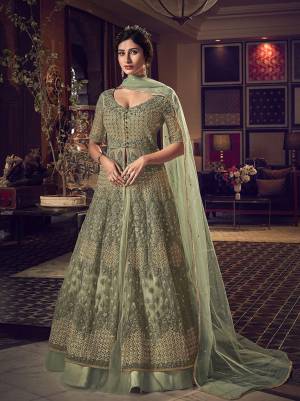 Here Is A Beautiful Pastel Green Colored Two Way Designer Suit With Comes With Two Bottom. Its Top Is Fabricated On Net Beautified With Heavy Embroidery Paired With Net Fabricated Lehenga And Art Silk Fabricated Embroidered Pants. Also It Has Net Fabricated Dupatta. 