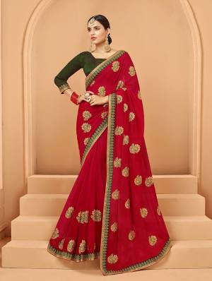 Catch All The Limelight At The Next Function You Attend In This Very Pretty Designer saree In Red Color Paired With Contrasting Olive Green Colored Blouse. It Is Beautified With Embroidered Motifs Giving An Elegant Look. Buy  This Saree Now.