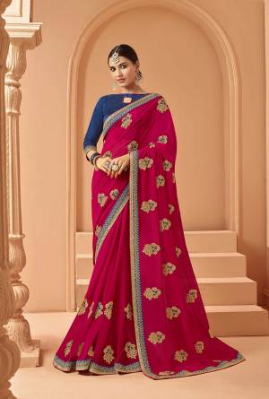 Catch All The Limelight At The Next Function You Attend In This Very Pretty Designer saree In Dark Pink Color Paired With Contrasting Navy Blue Colored Blouse. It Is Beautified With Embroidered Motifs Giving An Elegant Look. Buy  This Saree Now.