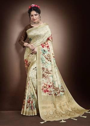 Celebrate This Festive Season With Beauty And Comfort In This Pretty Cream Colored Saree Paired  With Brown Colored Blouse. This Saree And Blouse Are Fabricated On Jacquard Silk Beautified With Weaving And Floral Digital Print. 