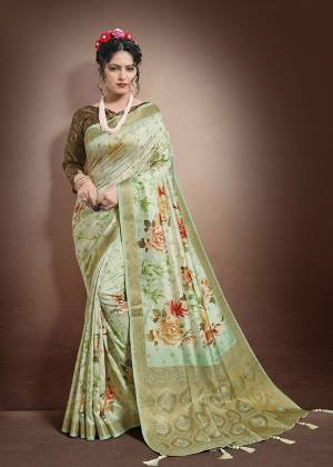 Grab This Lovely Floral Printed Designer Saree In Pastel Green Color Paired With Olive Green Colored Blouse. This Saree And Blouse Are Fabricated On Jacquard Silk Beautified With Weave And Digital Prints. It Is Light In Weight And Easy To Carry All Day Long. 