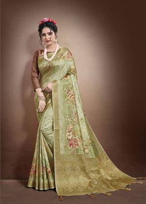 Celebrate This Festive Season With Beauty And Comfort In This Pretty Light Green Colored Saree Paired  With Brown Colored Blouse. This Saree And Blouse Are Fabricated On Jacquard Silk Beautified With Weaving And Floral Digital Print. 