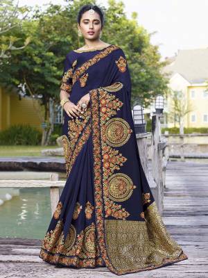Get Ready For The Upcoming Wedding Season With This Heavy Designer Saree In Navy Blue Color. This Pretty Heavy Embroidered Saree Is Fabricated On Satin Silk Paired With Art Silk Fabricated Blouse. It Has Very Pretty Detailed Embroidery Giving An Attractive Look. 