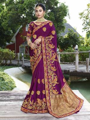 Get Ready For The Upcoming Wedding Season With This Heavy Designer Saree In Bright Purple Color. This Pretty Heavy Embroidered Saree Is Fabricated On Satin Silk Paired With Art Silk Fabricated Blouse. It Has Very Pretty Detailed Embroidery Giving An Attractive Look. 