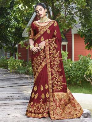 Get Ready For The Upcoming Wedding Season With This Heavy Designer Saree In Maroon Color. This Pretty Heavy Embroidered Saree Is Fabricated On Satin Silk Paired With Art Silk Fabricated Blouse. It Has Very Pretty Detailed Embroidery Giving An Attractive Look. 