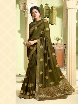 Celebrate This Festive Season With Beauty And Comfort Wearing This Designer Saree In Olive Green Color. This Pretty Saree Is Fabricated On Art Silk Paired With Jacquard Silk Fabricated Blouse. It Is Beautified With Jari Embroidery And Stone Work. 
