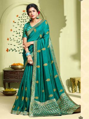 Celebrate This Festive Season With Beauty And Comfort Wearing This Designer Saree In Turquoise Blue Color. This Pretty Saree Is Fabricated On Art Silk Paired With Jacquard Silk Fabricated Blouse. It Is Beautified With Jari Embroidery And Stone Work. 