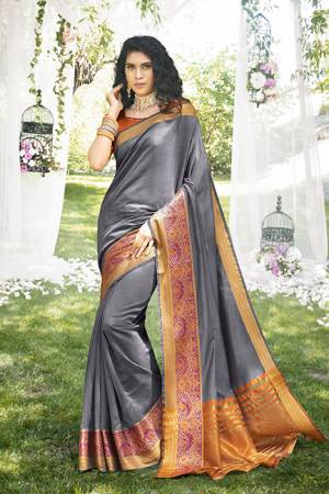 Simple And Elegant Looking Pretty Saree Is Here In Grey Color Paired With Orange Colored Blouse. This Saree And Blouse Are Fabricated On Khadi Silk Beautified With Weave Over The Saree Border. 