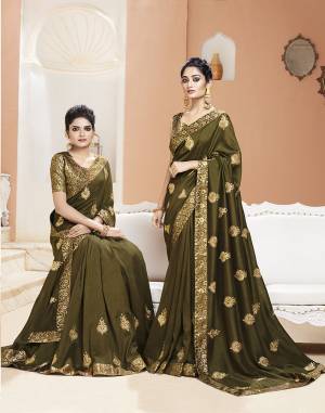 Celebrate This Festive Season Wearing This Designer Saree In Olive Green Color. This Saree Is Fabricated On Art Silk Paired With Brocade Fabricated Blouse. It Is Beautified with Jari Embroidery And Weaving. 