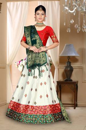 Go Colorful Wearing This Designer Silk Based Lehenga In Red, White And Dark Green Color. Its Pretty Blouse And Lehenga Are Fabricated On Satin Silk Paired With Bandhani Silk Dupatta. Its Fabric Is Durable, Light Weight And Easy To Carry Throughout The Gala. 