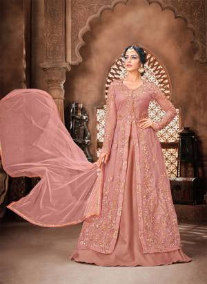 You Will Definitely Earn Lots Of Compliments Wearing This Lovely Indo-Western Heavy Designer Suit In Dusty Pink Color. Its Top Is Fabricated On Net paired With Satin Silk Bottom And Net Fabricated Dupatta. 
