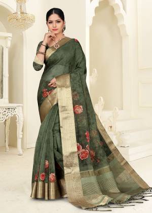 You Will Definitely Earn Lots Of Compliments Wearing This Designer Saree In Dark Green Color. This Saree Is Orgenza Based Beautified With Floral Prints. Buy This Saree Now.