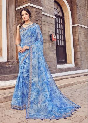 Grab This Beautiful Designer Saree In Blue Color. This Pretty Printed Saree Is Cotton Silk Based Paired With Art Silk Fabricated Blouse. Buy Now.
