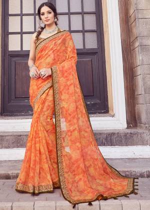 Here Is A Pretty Printed Saree In Orange Color. This Saree Is Fabricated On Cotton Silk Paired With Art Silk Fabricated Blouse. It Is Light In Weight And Easy To Carry All Day Long. 