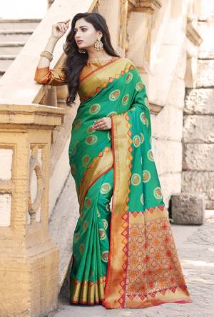 Flaunt Your Rich And Elegant Taste Wearing This Designer Silk Based Saree In Sea Green Color Paired With Golden Colored Blouse. This Saree And Blouse Are Fabricated On Banarasi Art Silk Beautified With Weave. Buy Now.