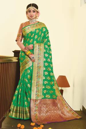For A Proper Traditional Look, Grab This Designer Silk Based Saree In Green Color Paired With Contrasting Purple Colored Blouse. This Saree And Blouse Are Fabricated On Art Silk Beautified With Weave. 