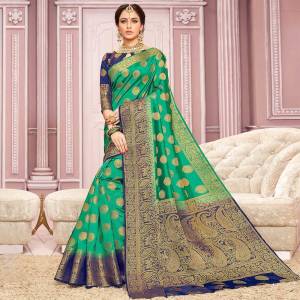 Here Is Rich And Elegant Looking Saree In Sea Green Color Paired With Navy Blue Colored blouse. This Saree Is Nylon Crepe Silk Based Paired With Art Silk Fabricated Blouse. 
