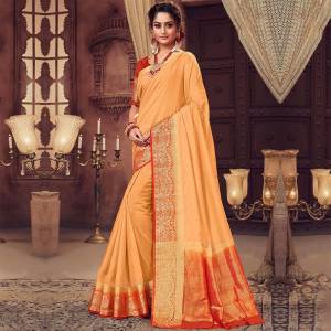 Celebrate This Festive Season With Beauty And Comfort Wearing This Light Orange Colored Saree. This saree and Blouse Are Silk Based Beautified With Weaved Border. Buy Now.